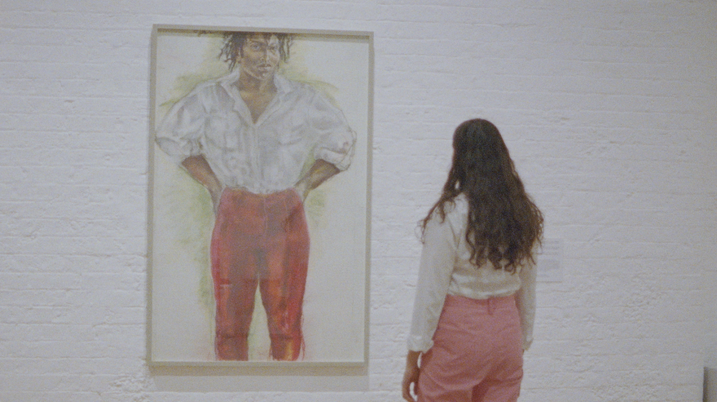 A woman with a long curly hair facing a life-sized portrait of a woman. Their clothes are almost identical.
