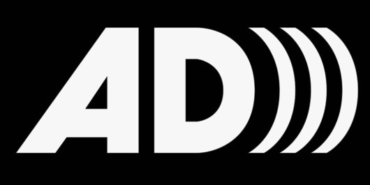 Audio Description symbal writes alphabet A and D in capital followed by three right bracket symbols.