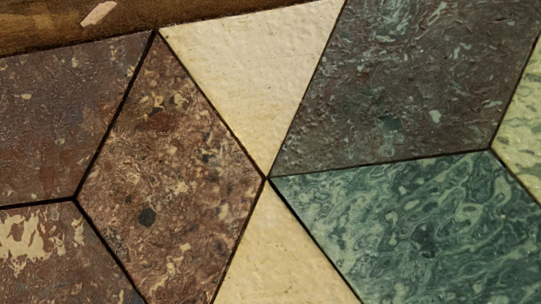 Various types of marbles in different colours are cut in trapezoid and triangle and are perfectly mosaiced. 