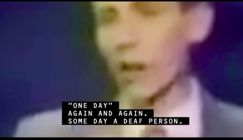 a blurry pixelated image of a white man's face in close up with the caption '"One Day" again and again. Some day a Deaf person.