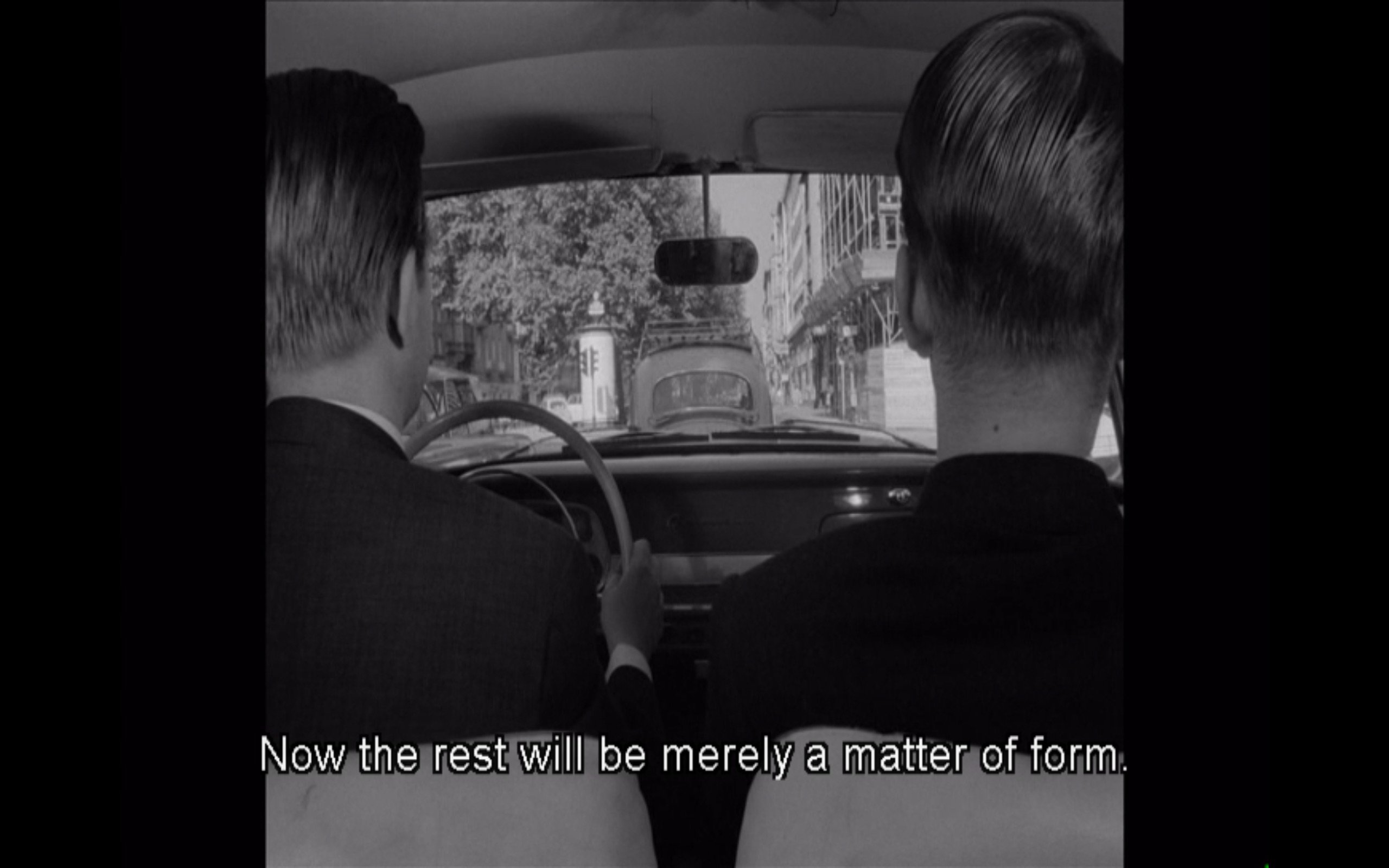 Backs of two men in the front seats of a car, viewed from the backseat. heavily masked by black bars on both sides. The caption on the bottom writes “Now the rest will be merely a matter of form.” 