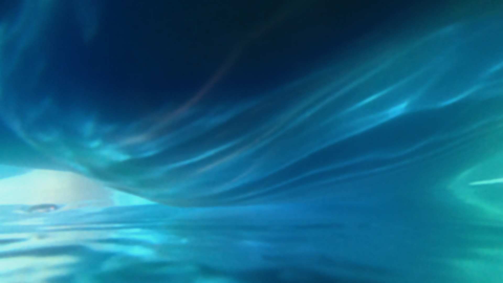 An abstract scene beneath the surface of water, where cool shades of blue and turquoise swirl. Light ripples create flowing patterns, with a sense of movement and fluidity