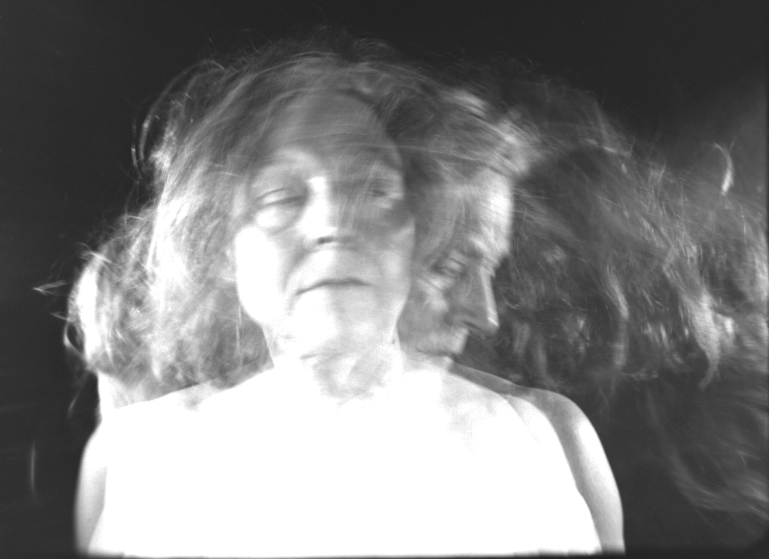 Layered Black and White Still of a Woman Standing facing the camera in multiple positions.