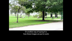 Soldiers lower to the ground, doing a training exercise in a green space in a park, framed by a black border. Beneath the image there’s a caption that reads: “Or another way of saying it is: how these images are put to work.”