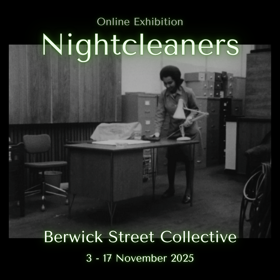 A black and white photograph of an office furnished with rows of paperwork cabinets. In the foreground stands a large wooden desk, behind which a person is wiping its surface with a cloth.