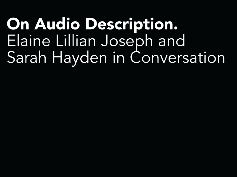 A black card that has captions on the top which reads “on audio description. Elaine Lillian Joseph and Sarah Hayden in conversation.”