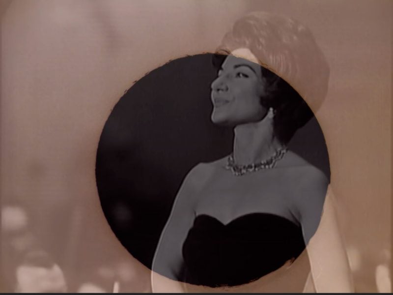 image from the film Maria by Nina Danino, a black and white image of singer Maria Callas looking to the side and wearing a black evening dress overlaid with a sepia tone with a circle in it.