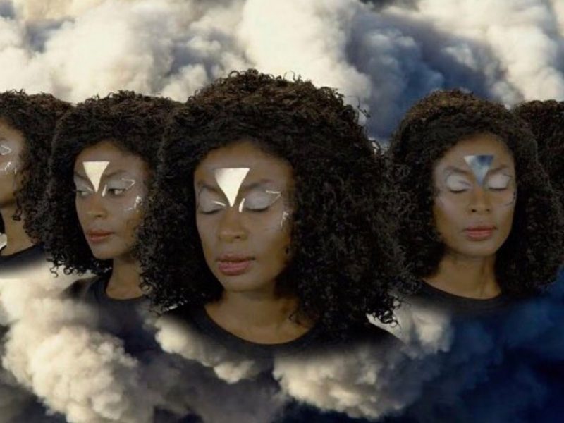 Five heads of black woman floating against the backdrop of a cloud of smoke