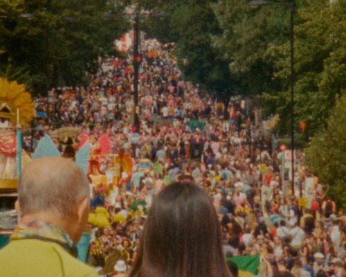 image of a crowded and colourful street at Notting Hill Carnival.
